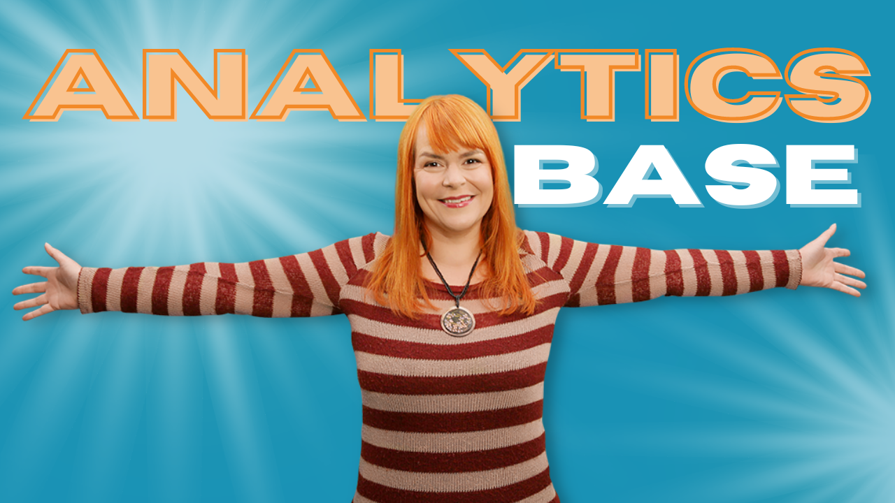 Amanda is a red head, she's wearing a deep red striped jumper and her arms are wide, welcoming you to Analytics Base